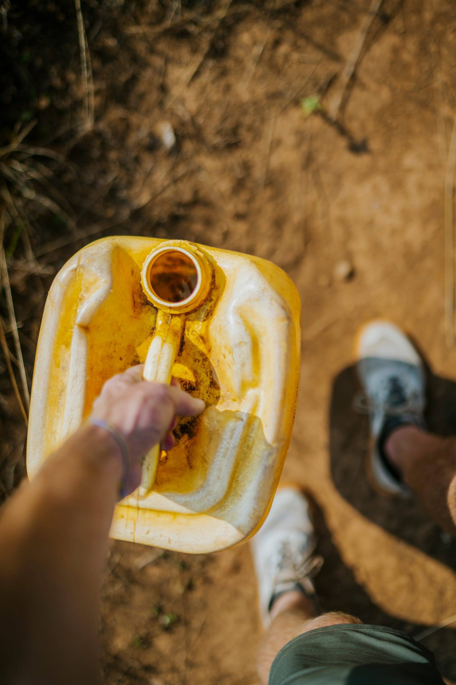 Clean water poured from a bright yellow container